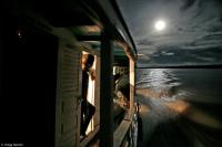 A full moon illuminates the way while traversing the Amazon River.