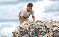 Child worker toils away at a waste dump in the capital of Brazil.