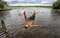 Kids enjoy a swim at flooded farmland in Amapá.