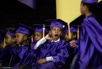 An underwhelmed boy during his kindergarten graduation ceremony.