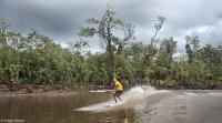 Lone surfer in a remote area on the Amazon River.