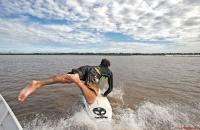 Jumping to catch a Pororoca tidal bore wave in the Amazon jungle.