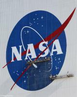 Painters refurbish the NASA logo on the Vehicle Assembly Building.