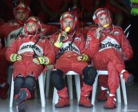A nap and ice cream for Ferrari pit crew during a Grand Prix race.