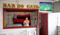 Serving beer to fans watching a game on TV in the far reaches of the Amazon.