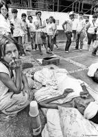 A crippled youth and friend beg for handouts in São Paulo.